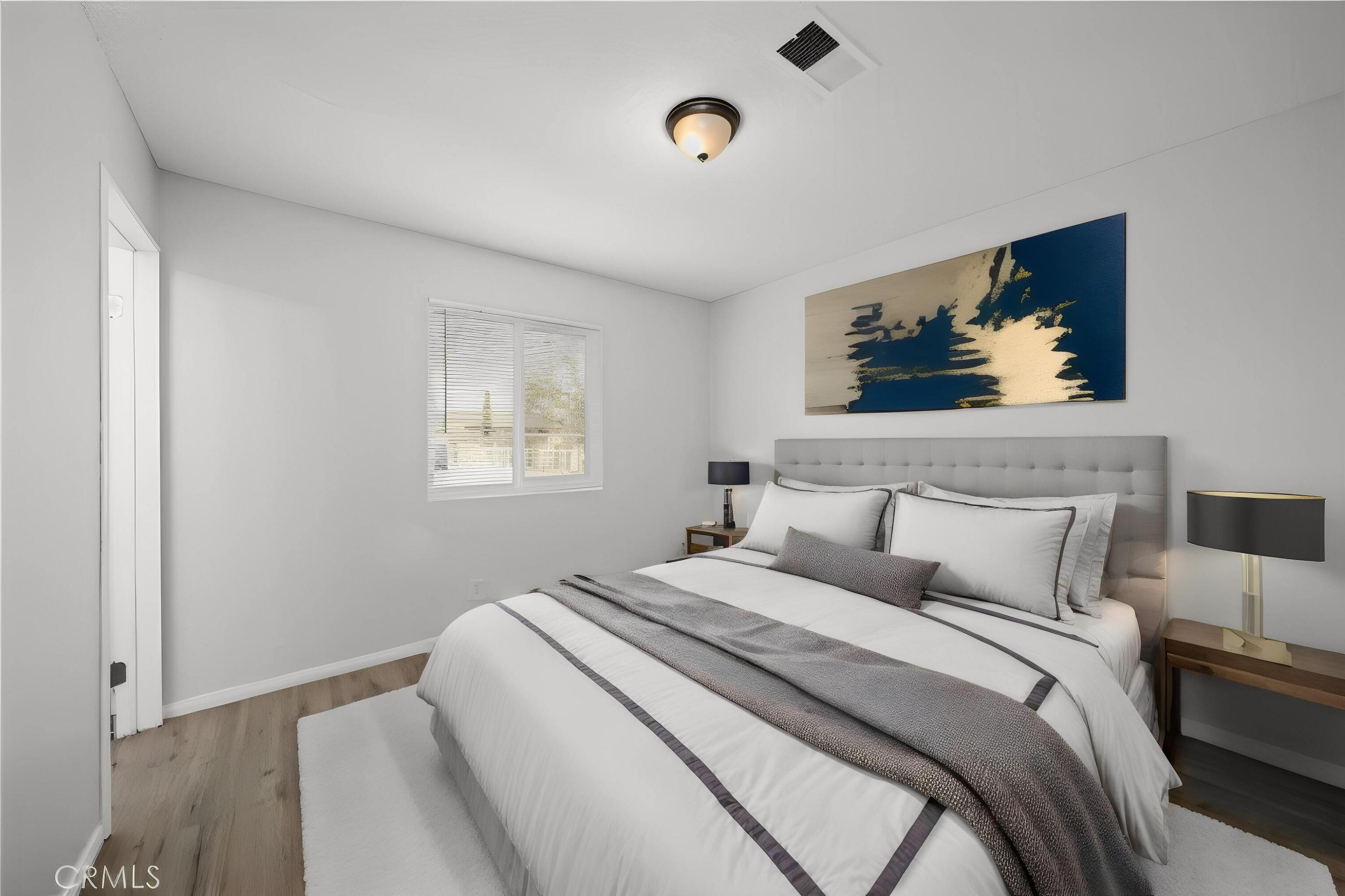 3360 West Roxbury Street Rosamond, CA 93560 - Photo 7 of 23 a bedroom with a bed and painting on the wall
