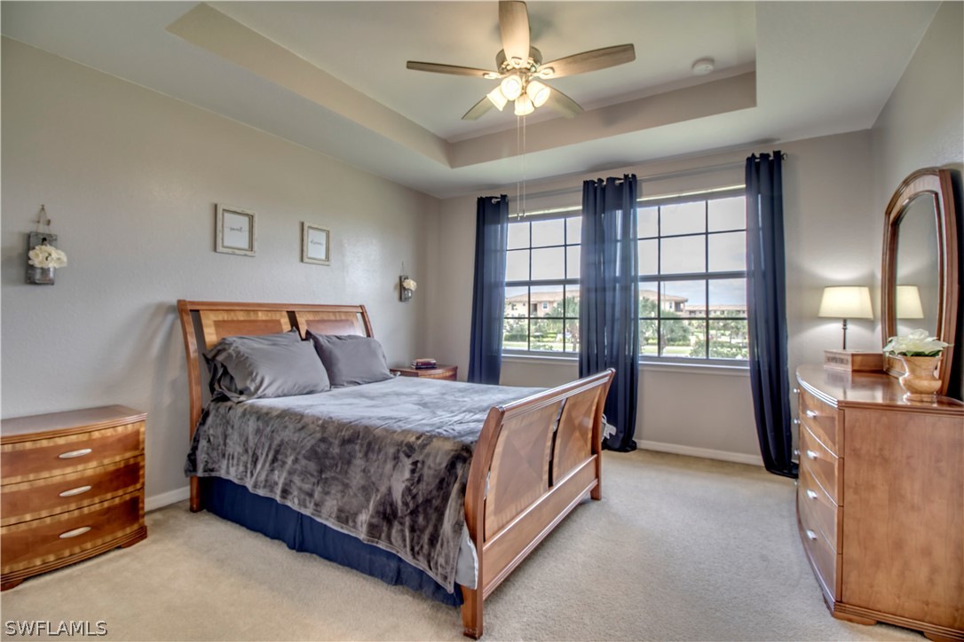 4084 Cherrybrook Loop Fort Myers, FL 33966 - Photo 11 of 29 a bedroom with a bed and a chandelier