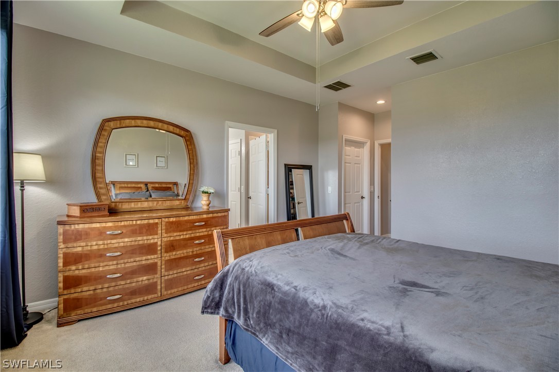 4084 Cherrybrook Loop Fort Myers, FL 33966 - Photo 12 of 29 a bedroom with a bed and a chandelier