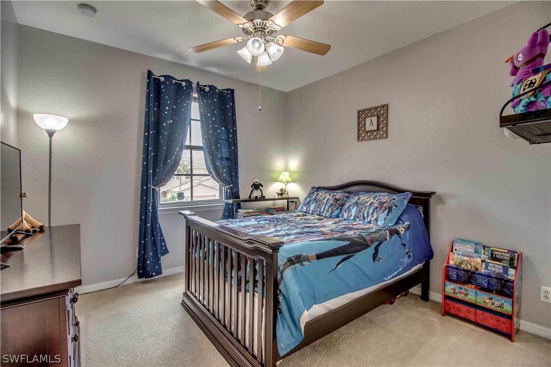 4084 Cherrybrook Loop Fort Myers, FL 33966 - Photo 15 of 29 a bedroom with a bed and a chandelier