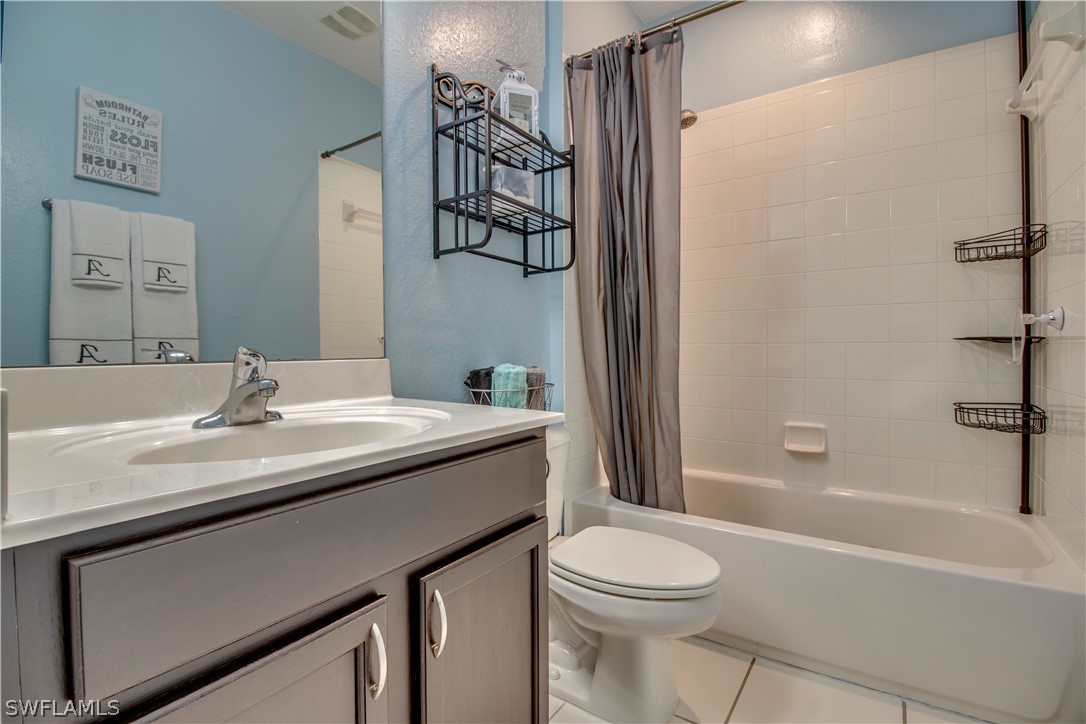 4084 Cherrybrook Loop Fort Myers, FL 33966 - Photo 16 of 29 a bathroom with a granite countertop sink toilet and shower