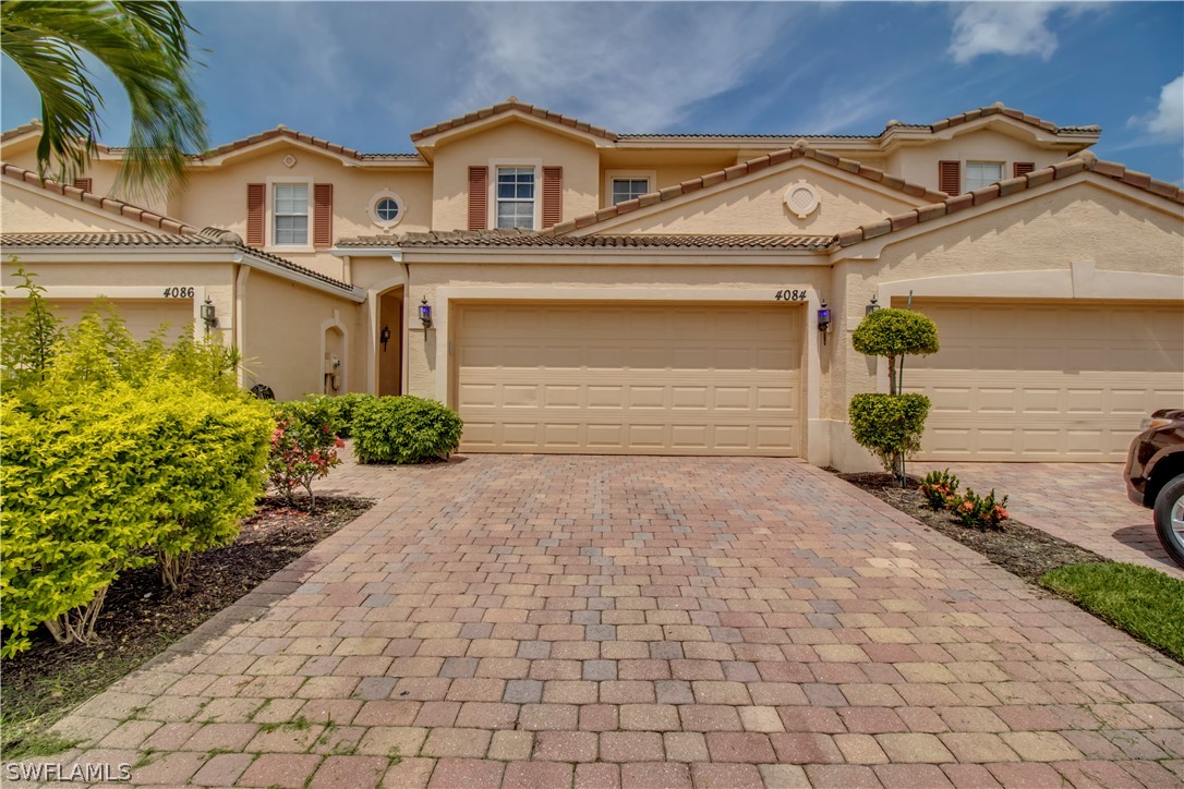 4084 Cherrybrook Loop Fort Myers, FL 33966 - Photo 23 of 29 a front view of a house with a yard and garage