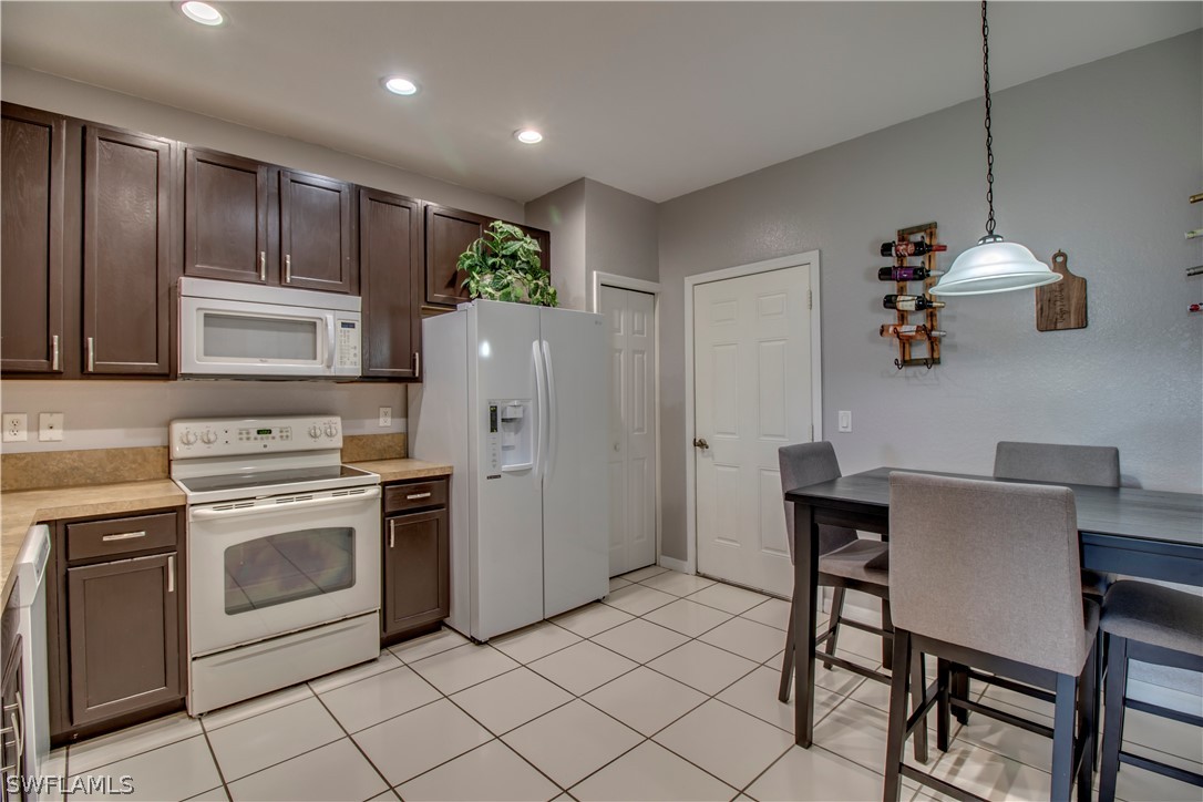 4084 Cherrybrook Loop Fort Myers, FL 33966 - Photo 8 of 29 a kitchen with a stove a sink and a refrigerator