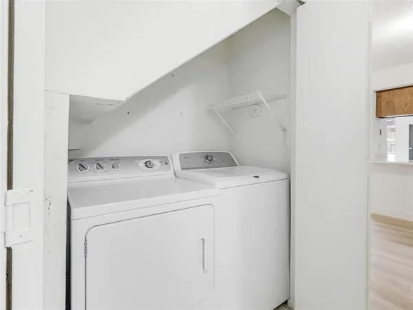 a view of a kitchen with a sink and a mirror