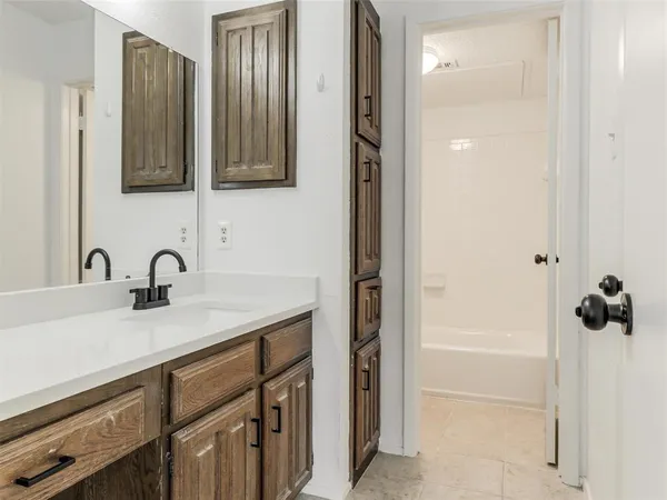 a bathroom with a sink a vanity and a mirror