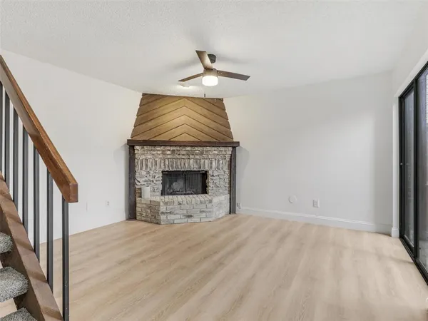 a view of staircase with white walls and a window