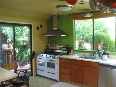 19598 Redwood Drive Monte Rio, CA 95462 - Photo 4 of 10 a kitchen with a stove a sink and a wooden cabinets