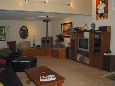 19598 Redwood Drive Monte Rio, CA 95462 - Photo 5 of 10 a living room with furniture a flat screen tv and a fireplace