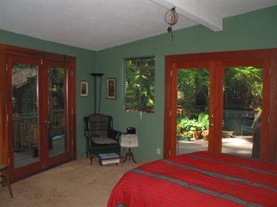 19598 Redwood Drive Monte Rio, CA 95462 - Photo 6 of 10 a bedroom with a bed and wooden floor
