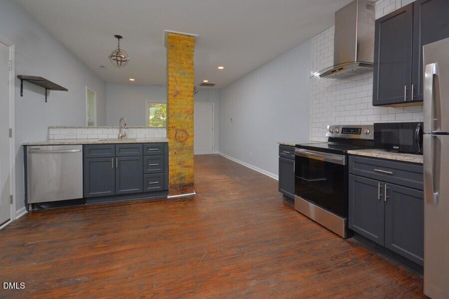 1030 Cornell Street, Unit B Durham, NC 27707 - Photo 11 of 22 a kitchen with stainless steel appliances granite countertop a stove a sink and a refrigerator