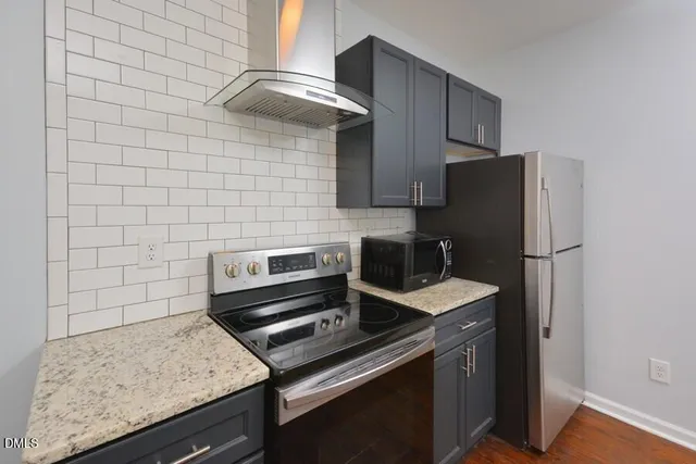 a kitchen with a stove and a refrigerator