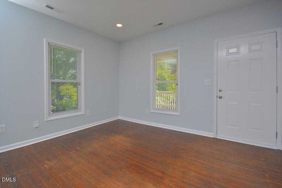 1030 Cornell Street, Unit B Durham, NC 27707 - Photo 5 of 22 a view of an empty room with wooden floor and a window