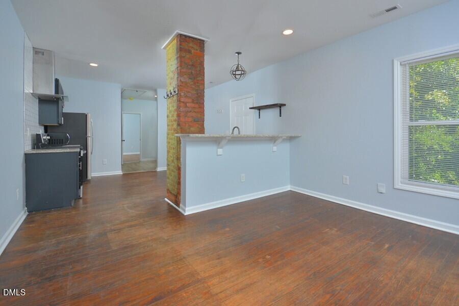 1030 Cornell Street, Unit B Durham, NC 27707 - Photo 6 of 22 a view of a kitchen with a sink and a refrigerator