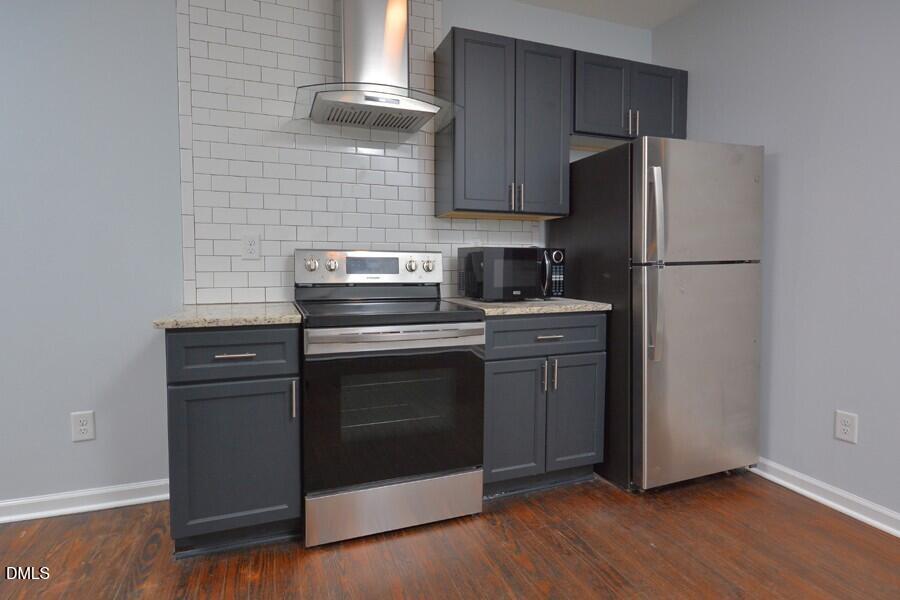 1030 Cornell Street, Unit B Durham, NC 27707 - Photo 7 of 22 a kitchen with a white stove and refrigerator