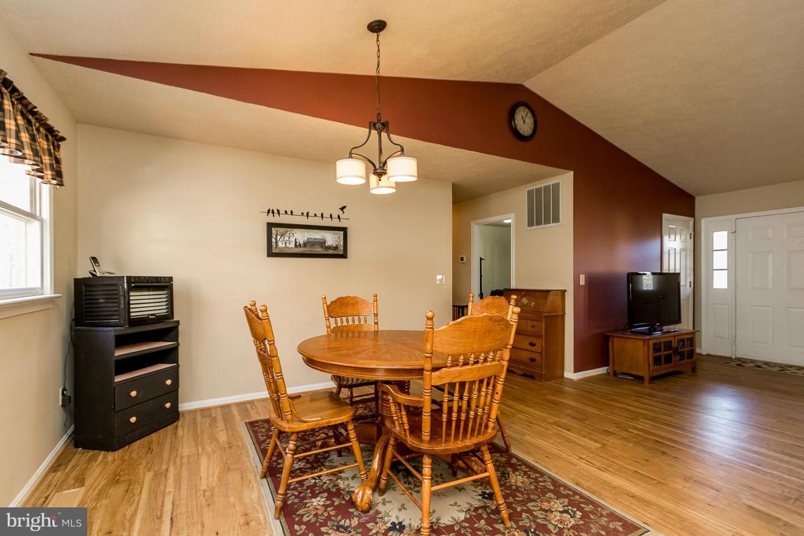 9509 Dutch Hollow Road Rixeyville, VA 22737 - Photo 22 of 29 a dining room with a wooden table and chairs