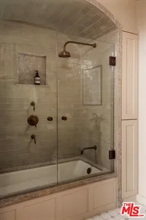 a bathroom with a bathtub and a shower