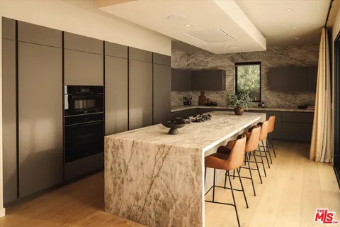 a kitchen with stainless steel appliances a refrigerator and a stove