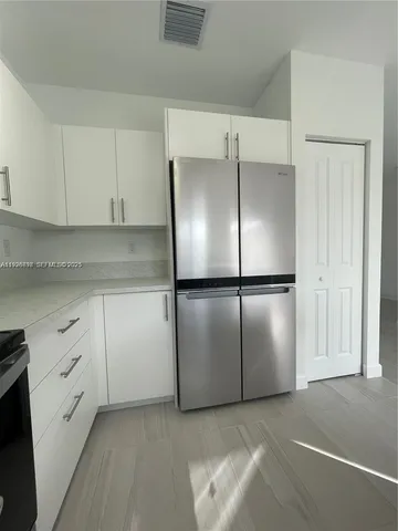 a kitchen with cabinets and stainless steel appliances