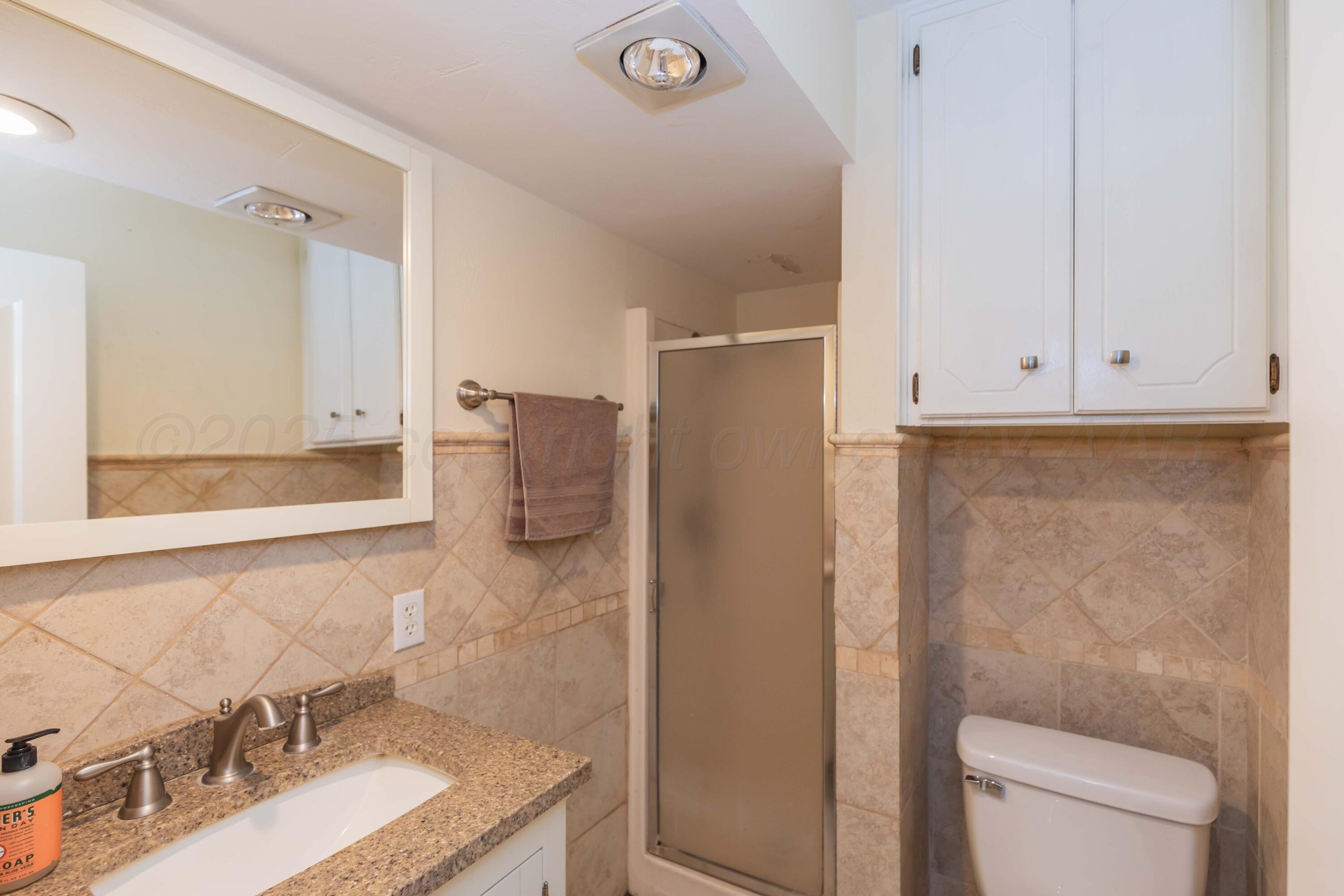 4427 Summit Circle Amarillo, TX 79109 - Photo 12 of 50 a bathroom with a granite countertop sink and a mirror