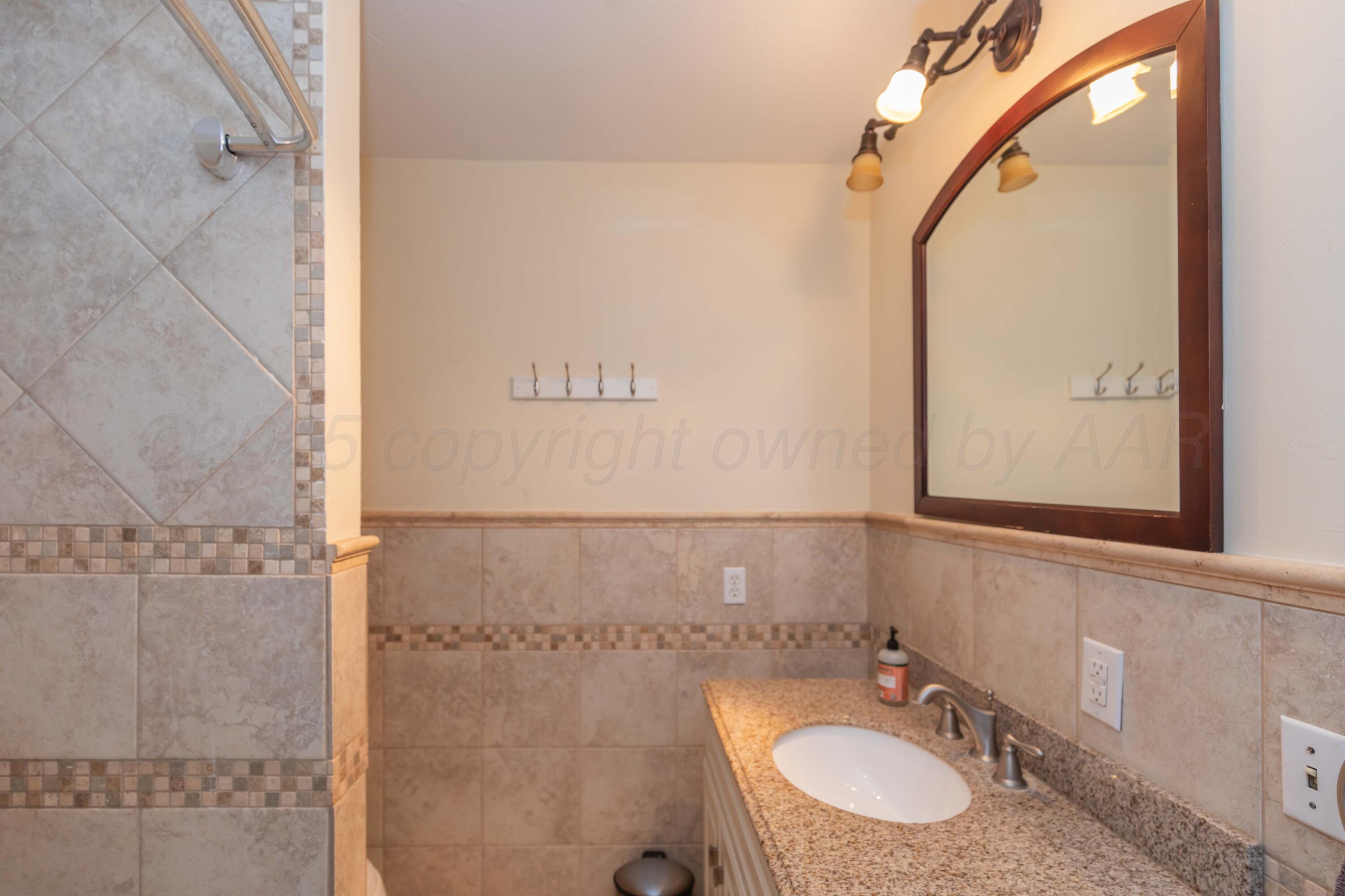 4427 Summit Circle Amarillo, TX 79109 - Photo 14 of 50 a bathroom with a sink and a mirror