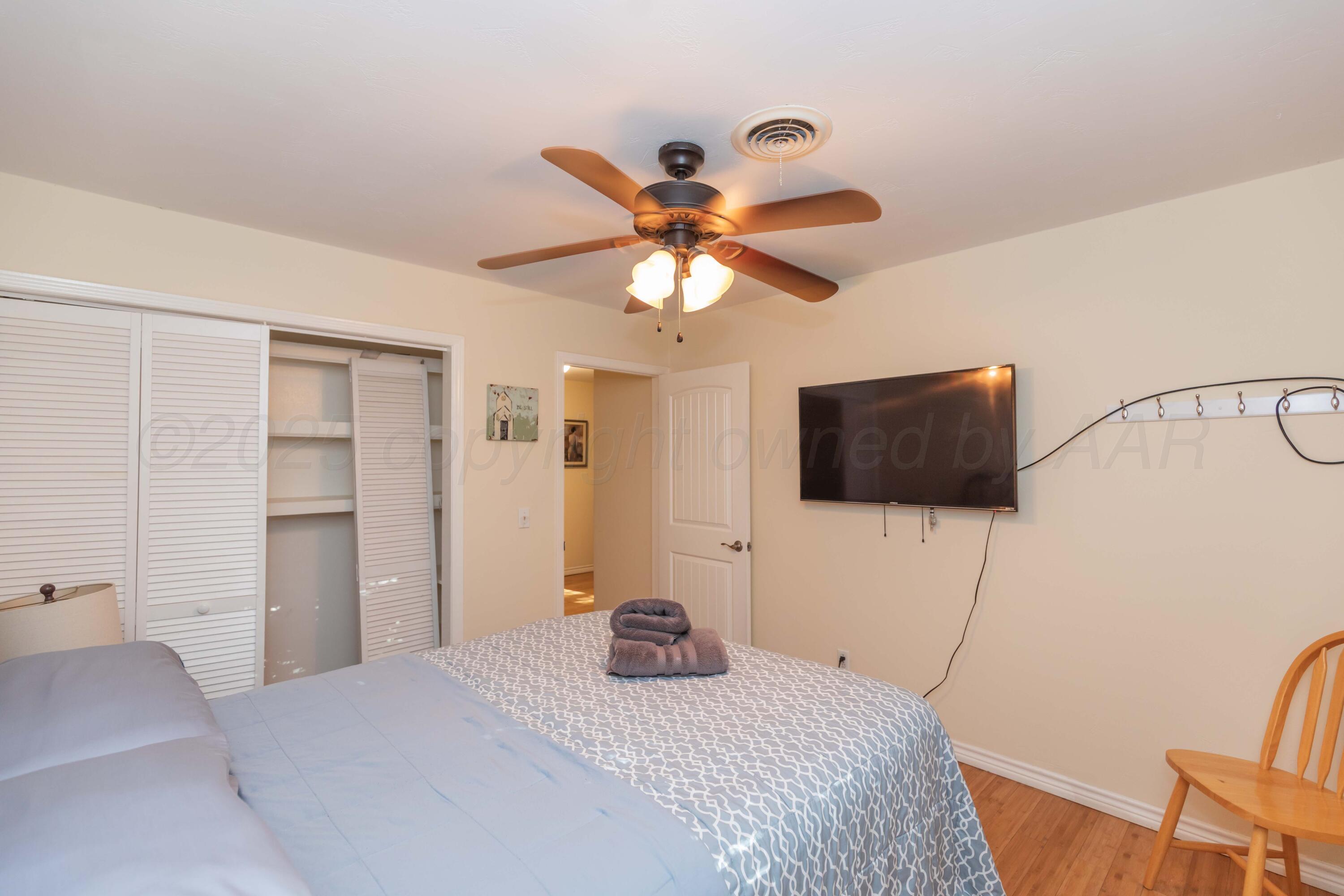 4427 Summit Circle Amarillo, TX 79109 - Photo 20 of 50 a bedroom with a bed and a flat screen tv