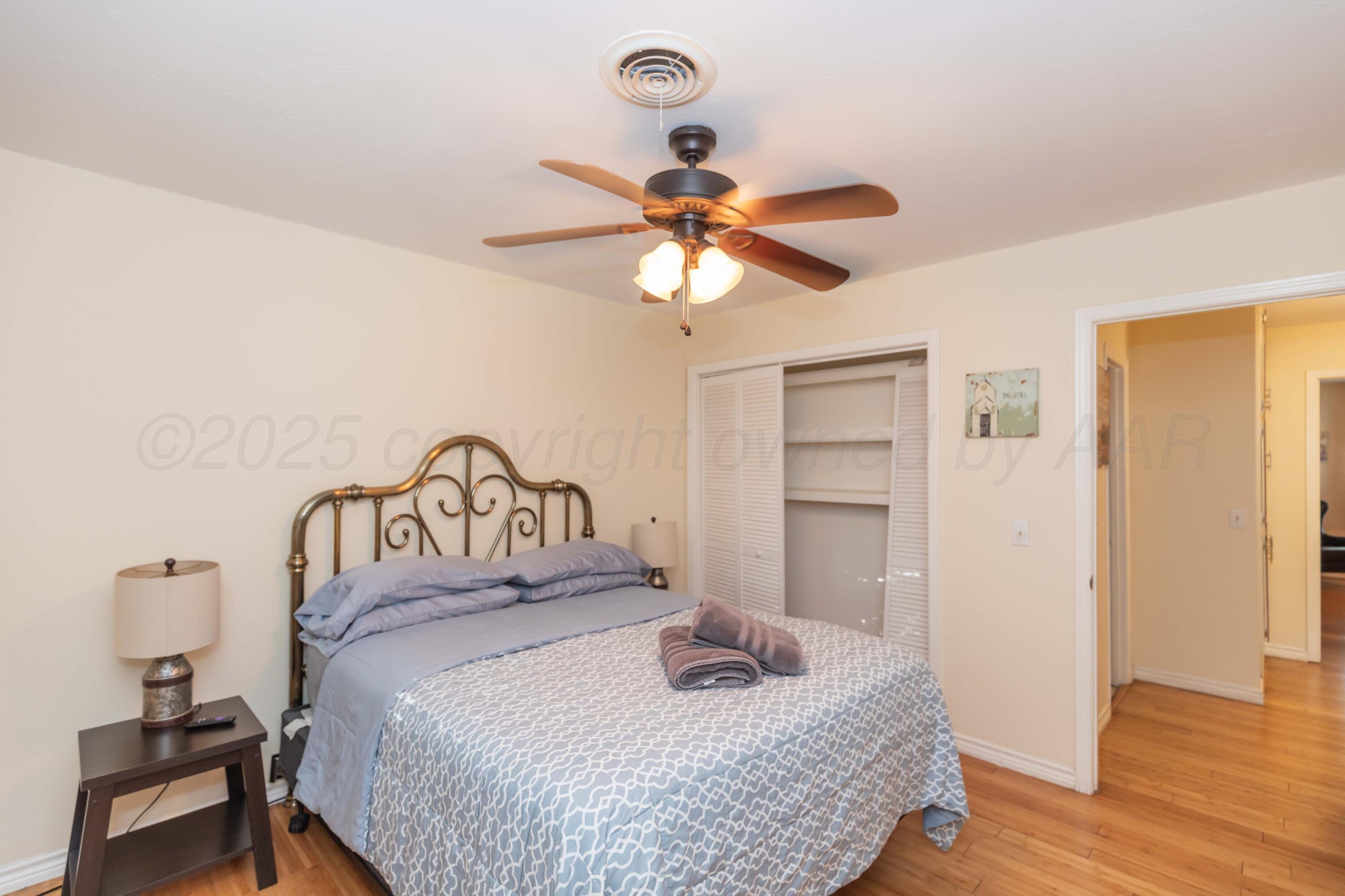 4427 Summit Circle Amarillo, TX 79109 - Photo 21 of 50 a bedroom with a bed and a chandelier