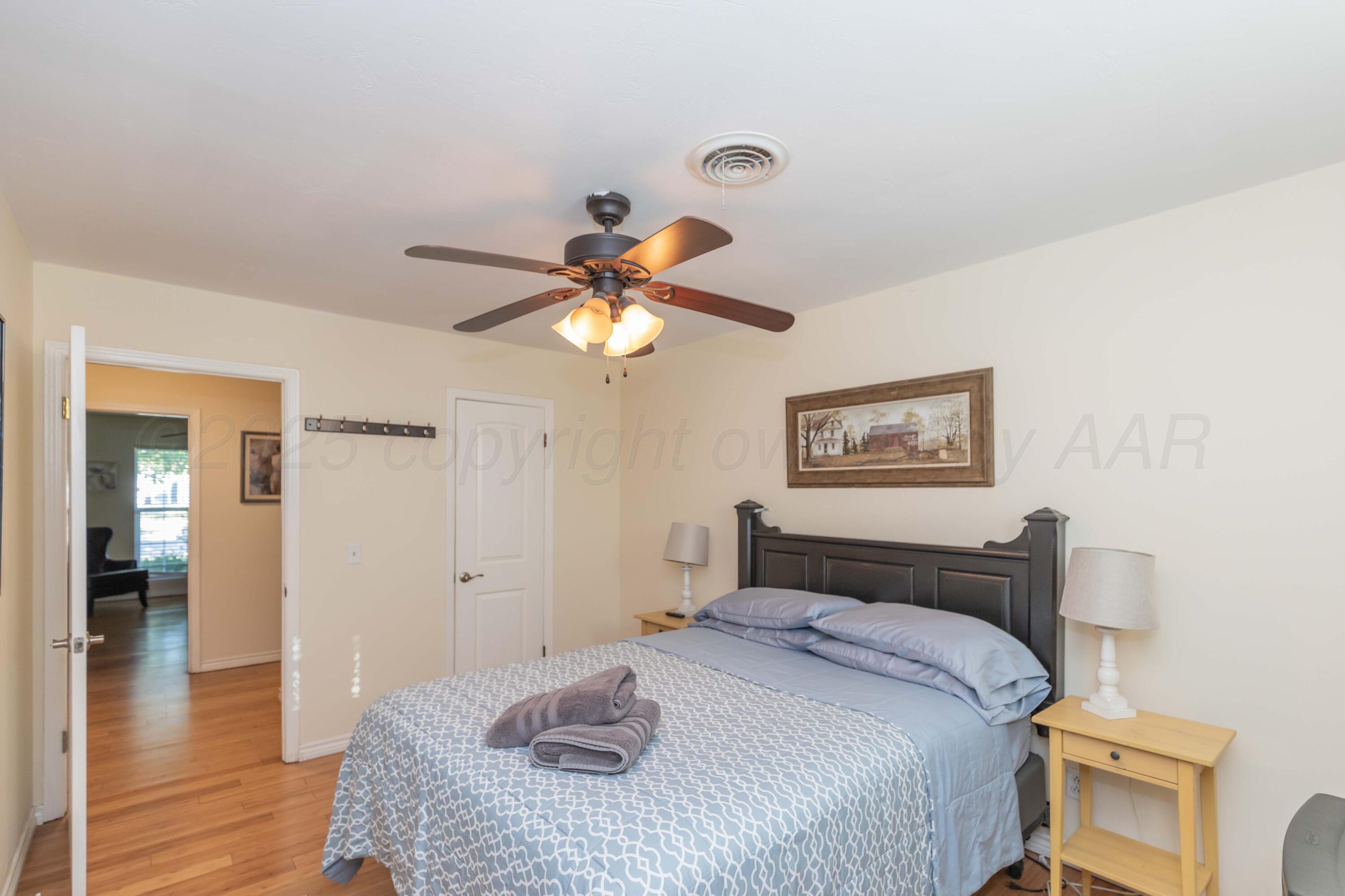 4427 Summit Circle Amarillo, TX 79109 - Photo 24 of 50 a bedroom with a bed and a chandelier