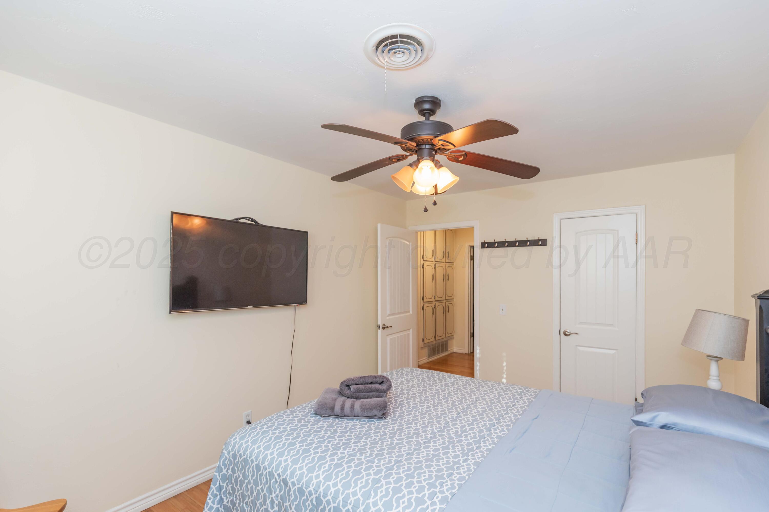 4427 Summit Circle Amarillo, TX 79109 - Photo 25 of 50 a bedroom with a bed and a flat screen tv