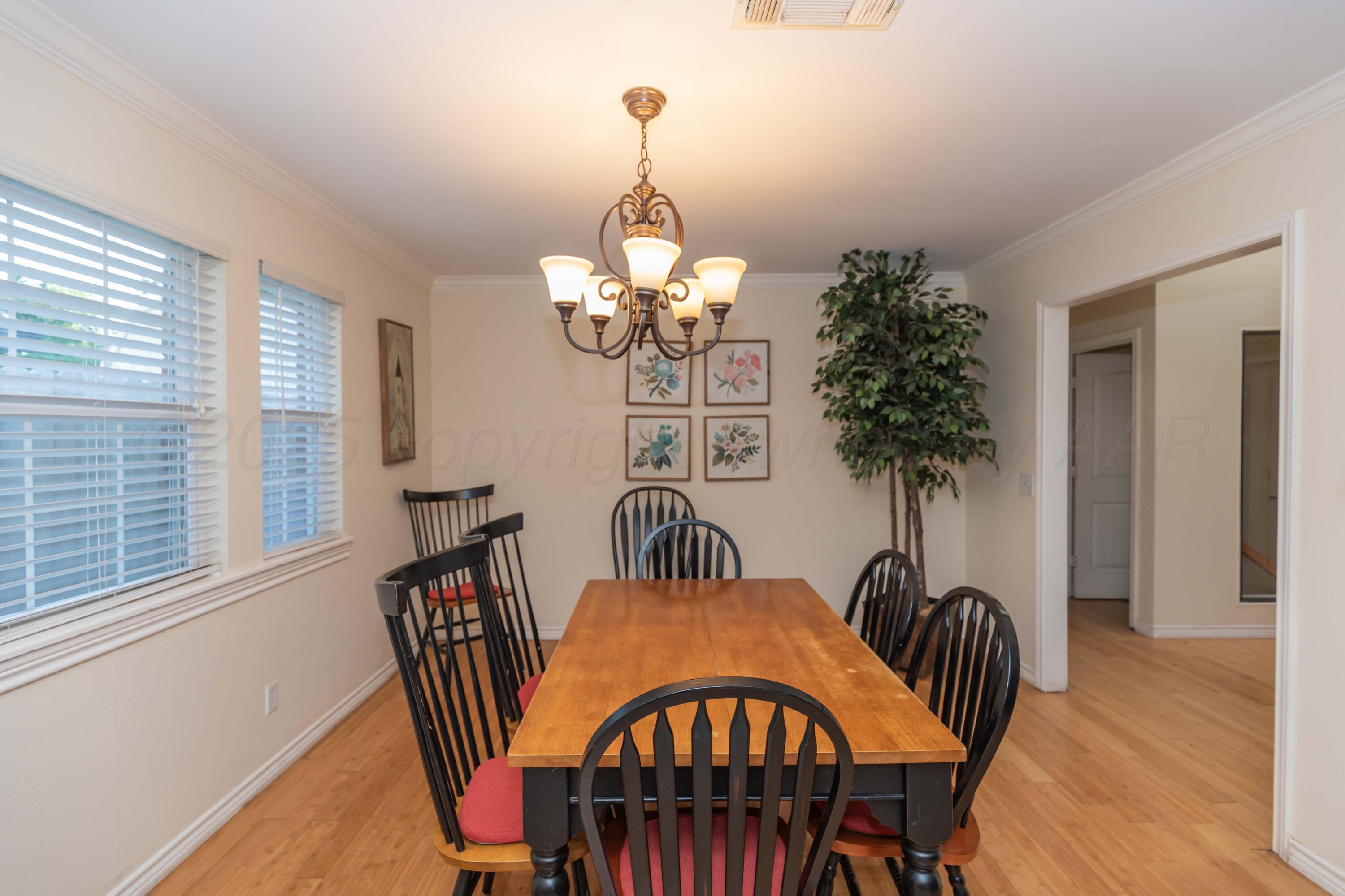 4427 Summit Circle Amarillo, TX 79109 - Photo 32 of 50 a view of a dining room with furniture window and wooden floor