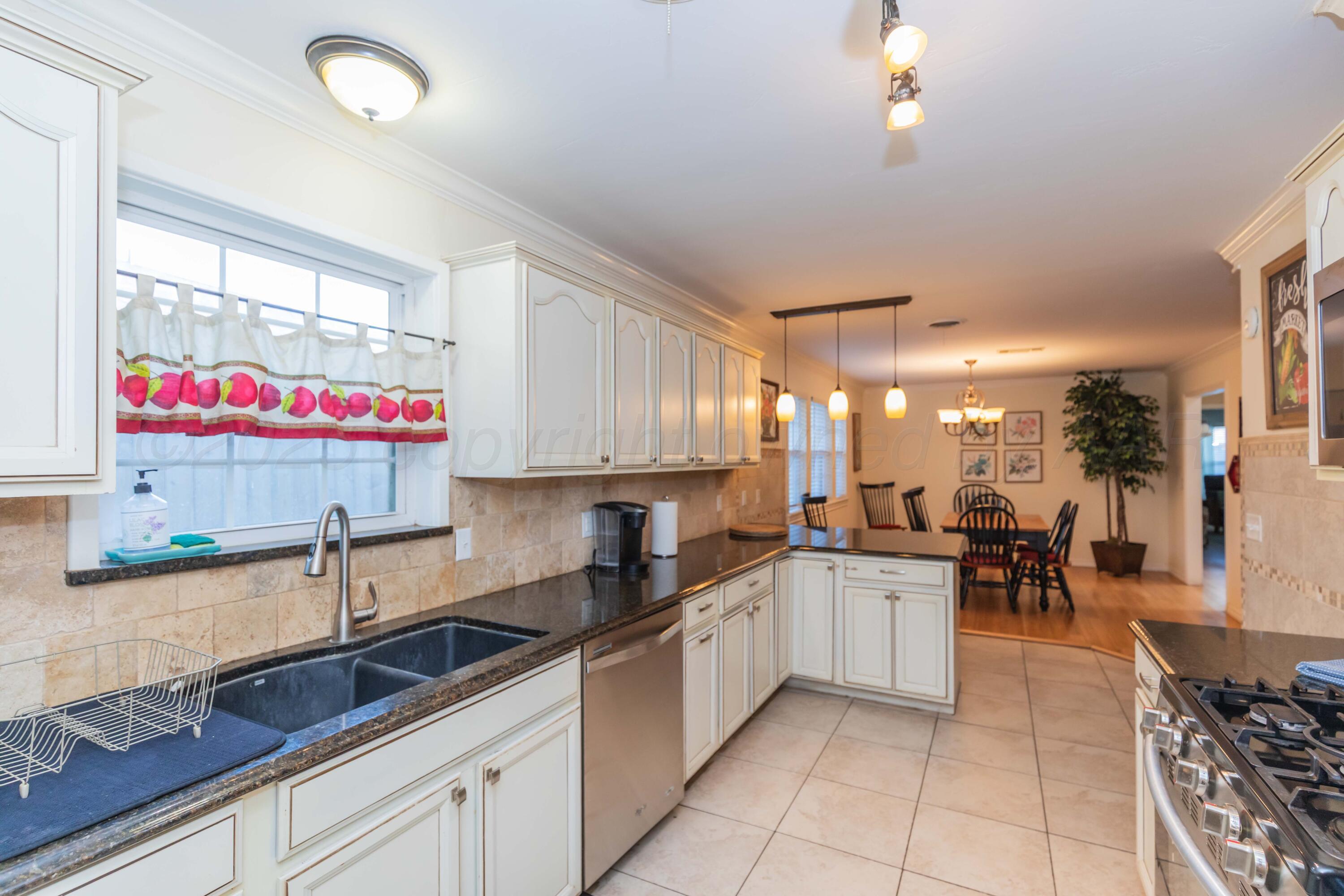 4427 Summit Circle Amarillo, TX 79109 - Photo 38 of 50 a kitchen with stainless steel appliances a sink counter space and a window