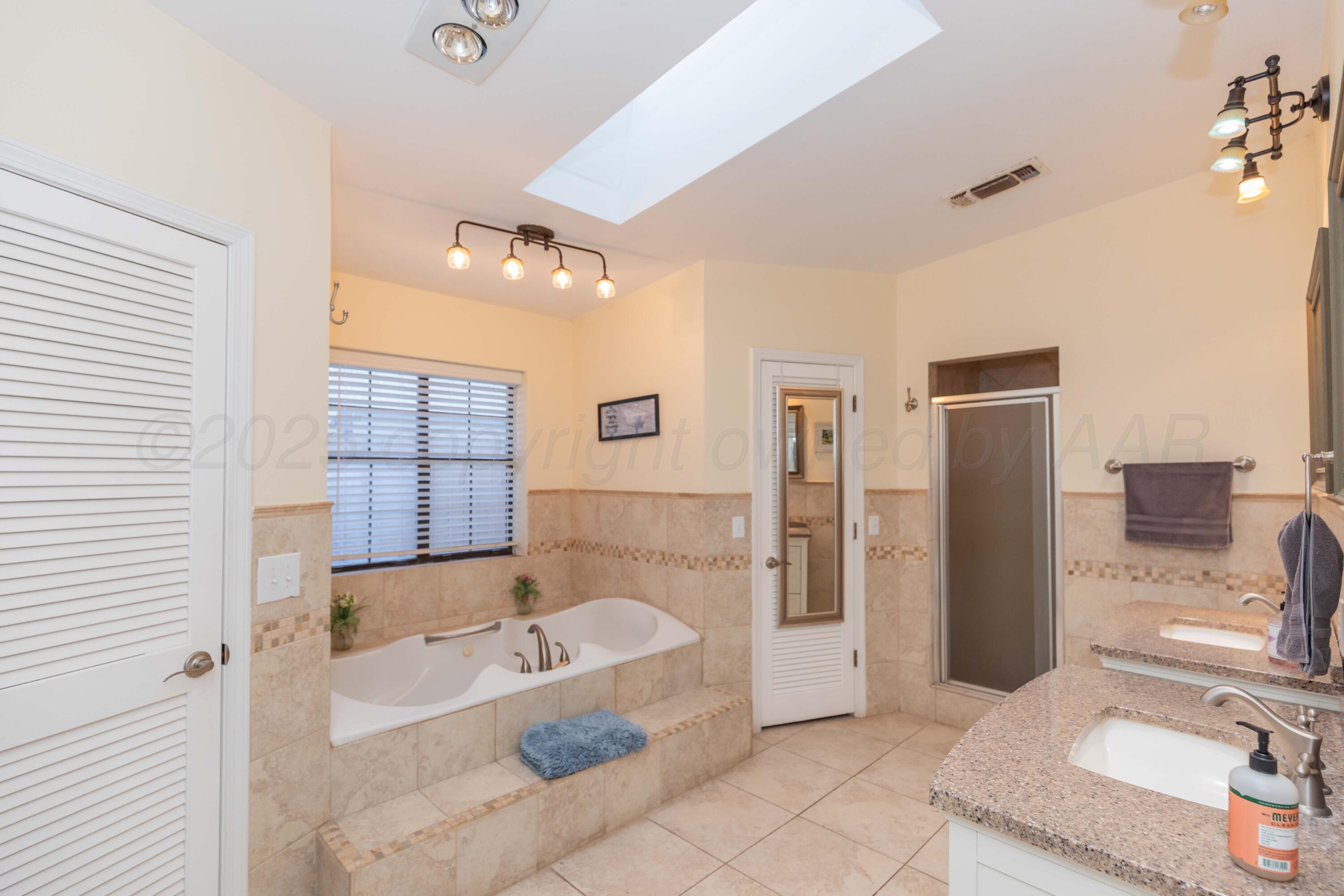 4427 Summit Circle Amarillo, TX 79109 - Photo 41 of 50 a bathroom with a bathtub shower and a sink