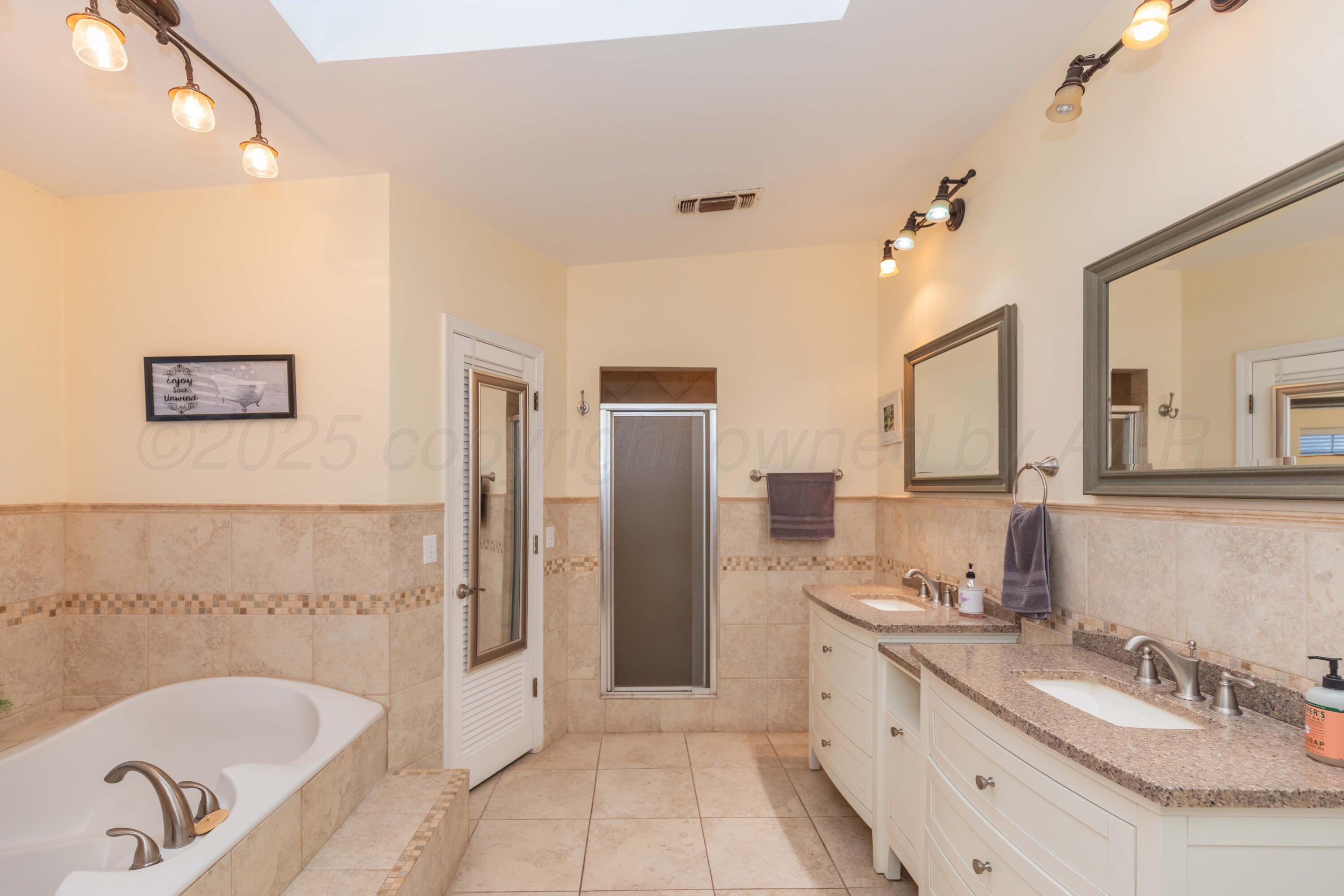 4427 Summit Circle Amarillo, TX 79109 - Photo 42 of 50 a bathroom with a granite countertop tub sink and mirror