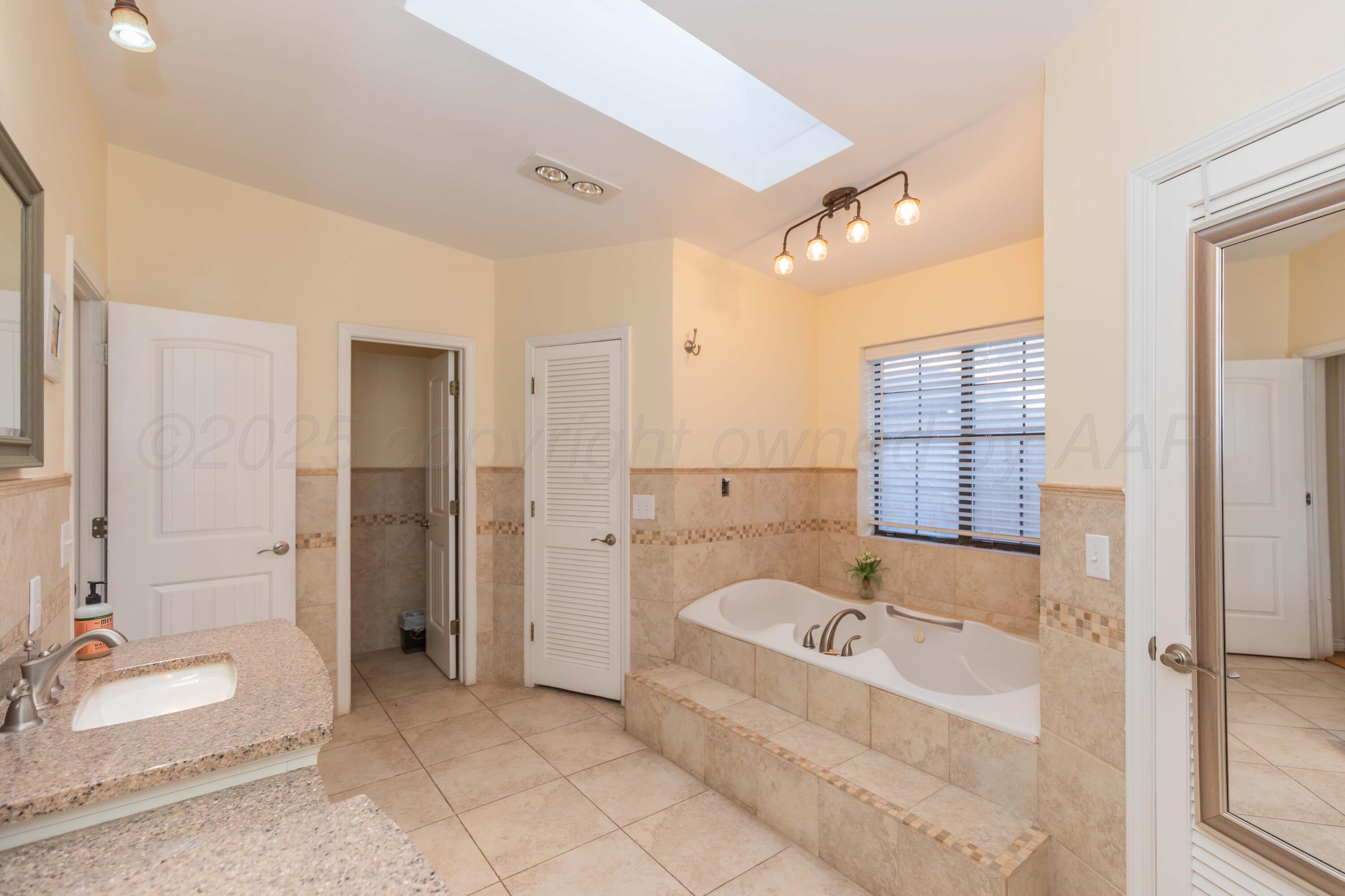 4427 Summit Circle Amarillo, TX 79109 - Photo 43 of 50 a bathroom with a tub and a shower