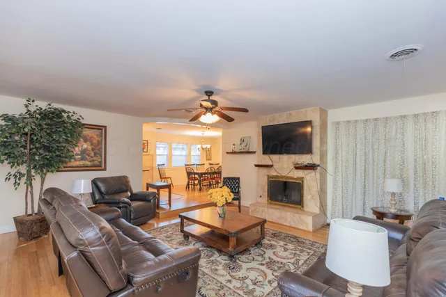 a living room with furniture fireplace and flat screen tv