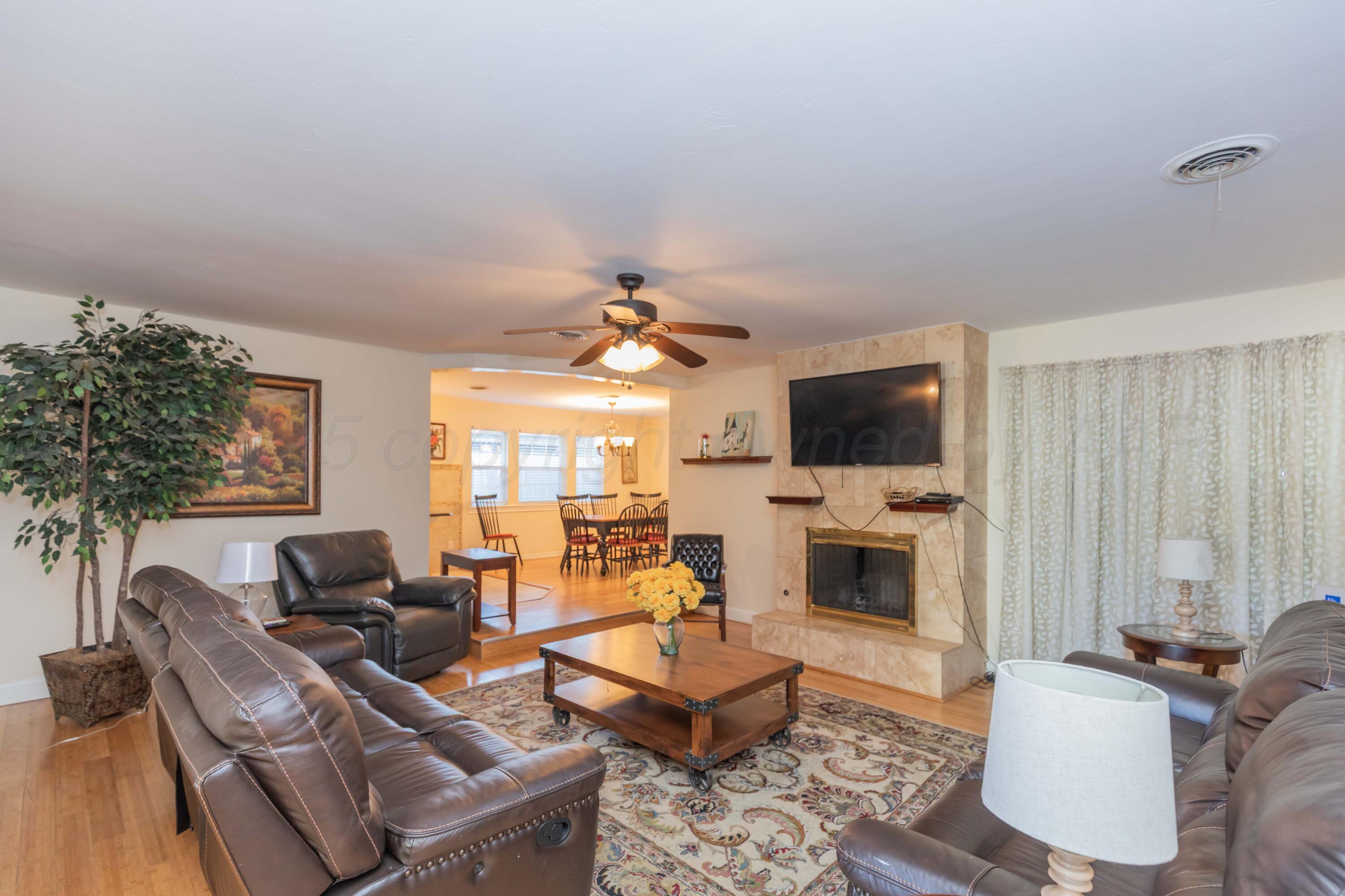 4427 Summit Circle Amarillo, TX 79109 - Photo 5 of 50 a living room with furniture fireplace and flat screen tv