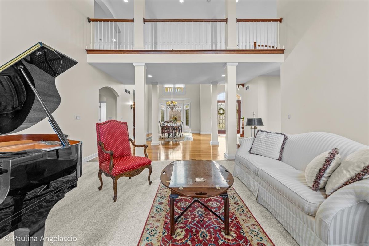 1175 Woodburn Court Inverness, IL 60067 - Photo 12 of 68 a living room with furniture a flat screen tv and kitchen view