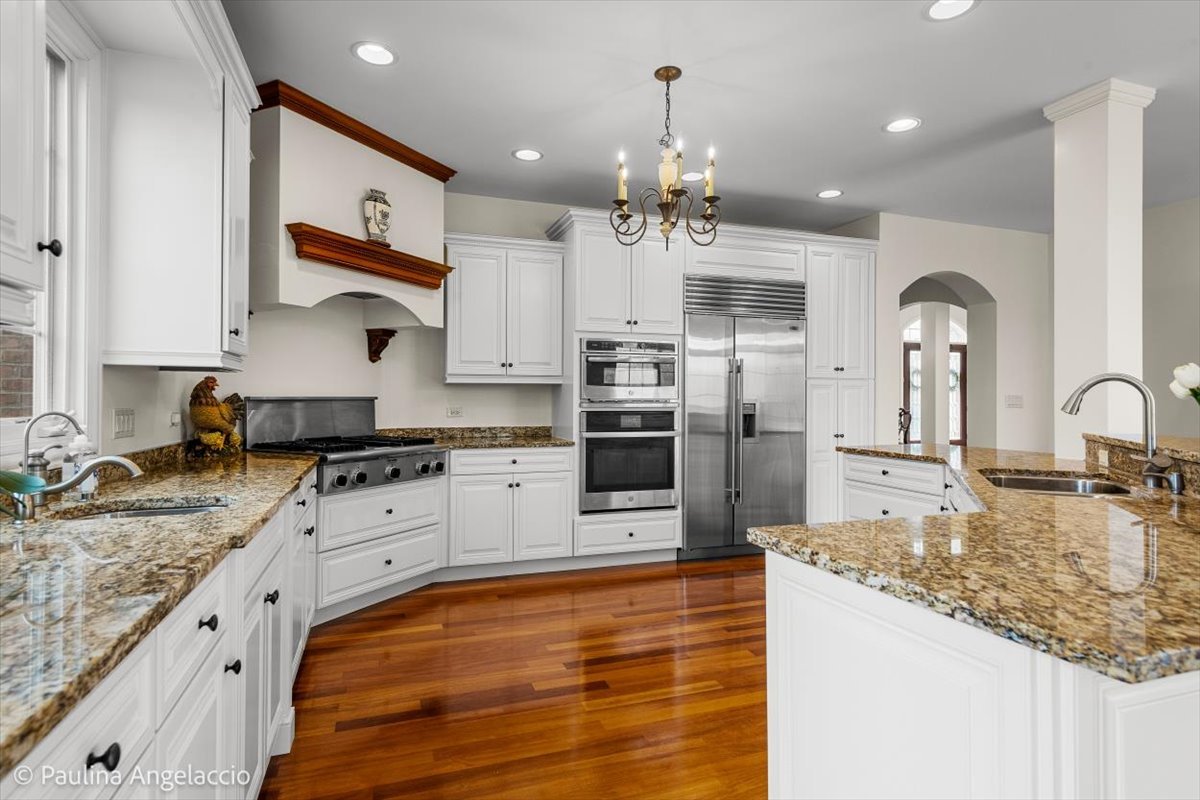 1175 Woodburn Court Inverness, IL 60067 - Photo 18 of 68 a large kitchen with stainless steel appliances granite countertop a lot of counter space and wooden floor