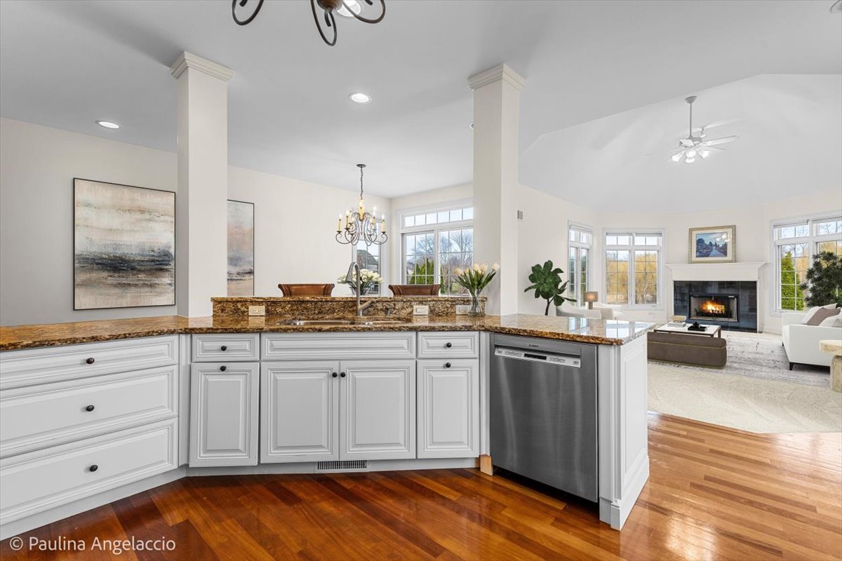 1175 Woodburn Court Inverness, IL 60067 - Photo 19 of 68 a large kitchen with kitchen island white cabinets and stainless steel appliances