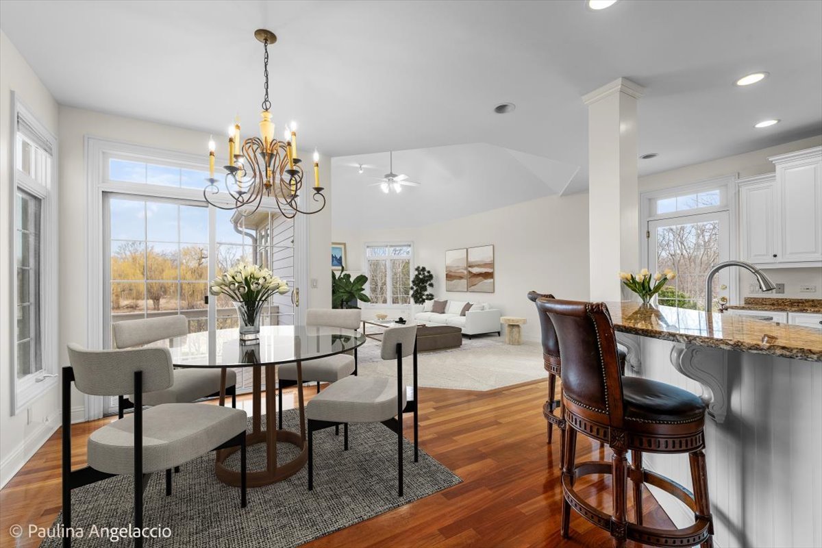 1175 Woodburn Court Inverness, IL 60067 - Photo 20 of 68 a view of a dining room with furniture a chandelier and wooden floor