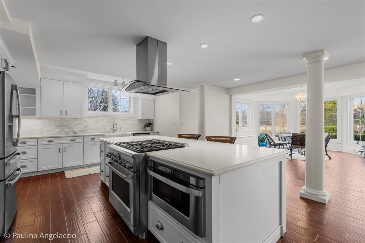 1175 Woodburn Court Inverness, IL 60067 - Photo 44 of 68 a kitchen with a stove a sink and wooden floor