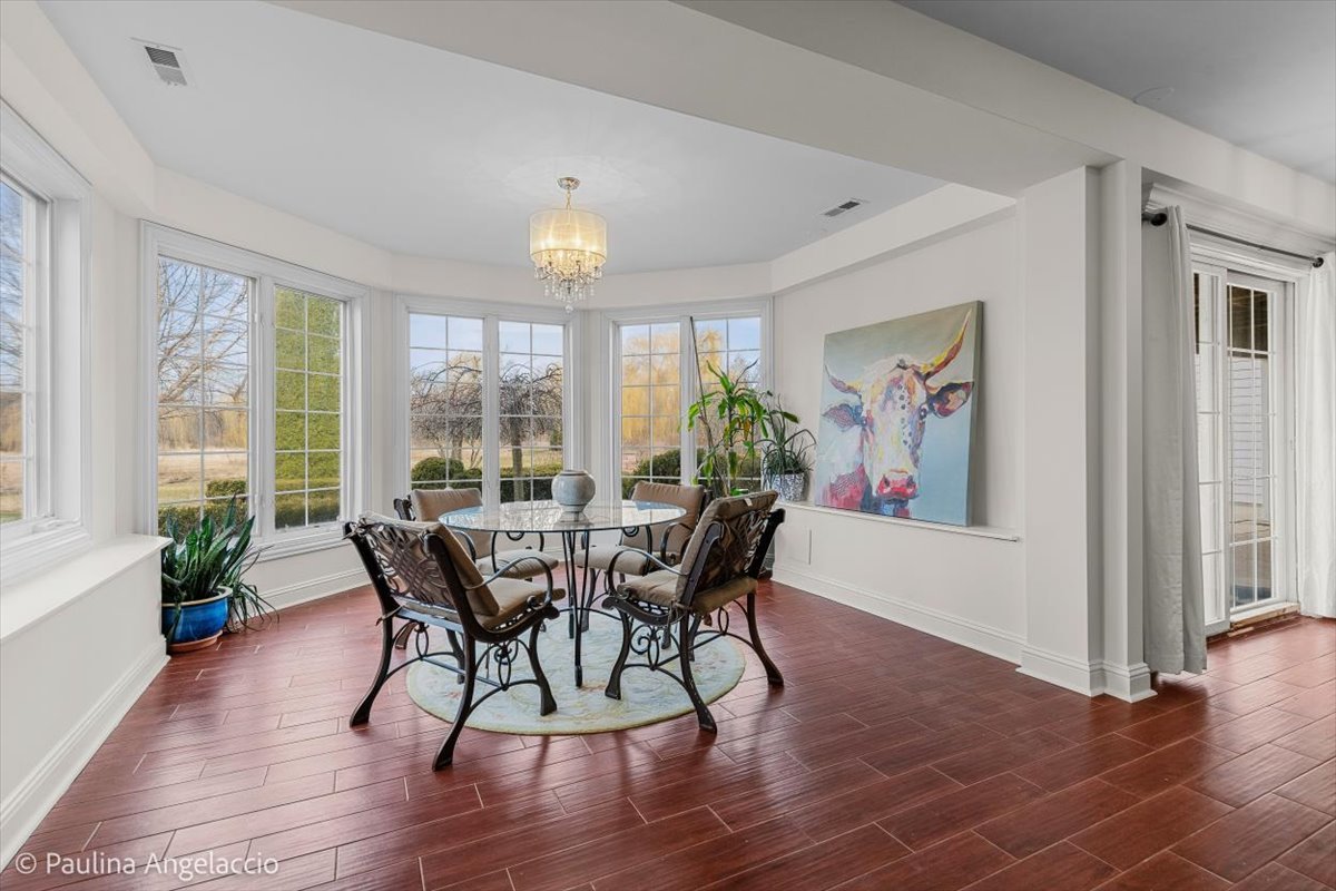 1175 Woodburn Court Inverness, IL 60067 - Photo 45 of 68 a view of a dining room with furniture and wooden floor