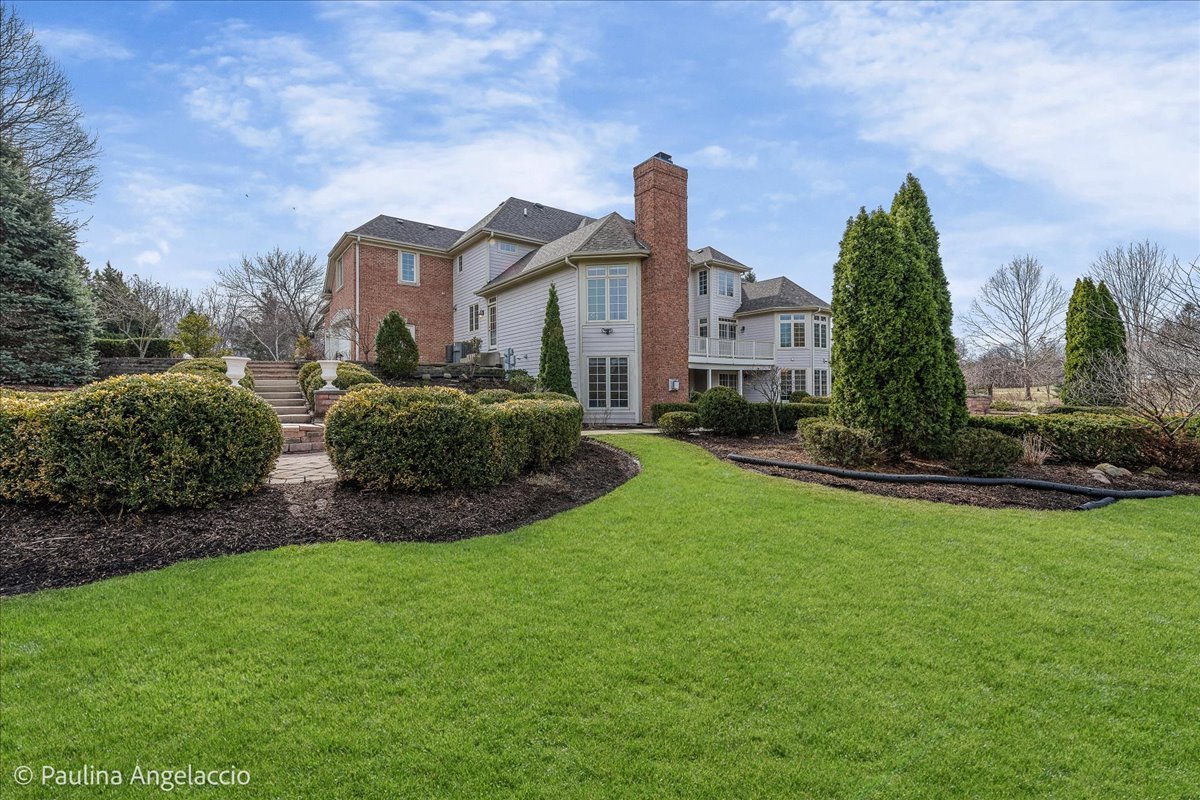 1175 Woodburn Court Inverness, IL 60067 - Photo 59 of 68 a front view of a house with a garden