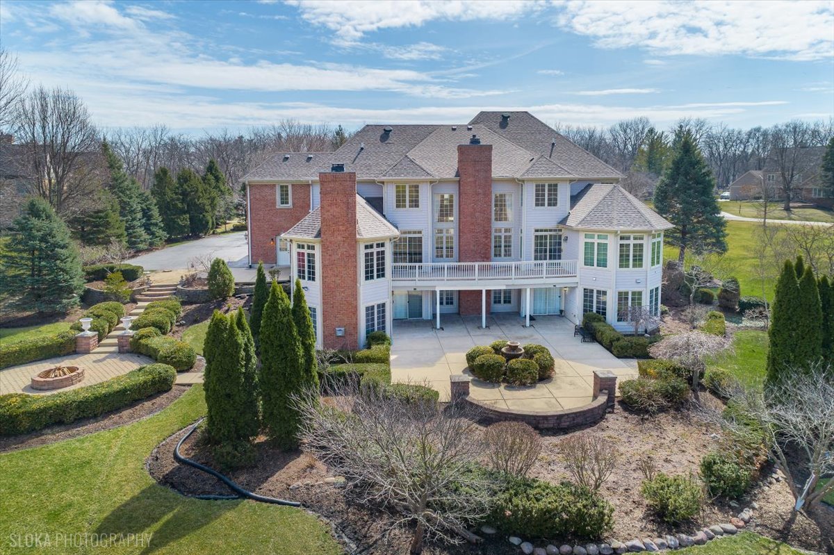1175 Woodburn Court Inverness, IL 60067 - Photo 61 of 68 a front view of a house with a garden and plants