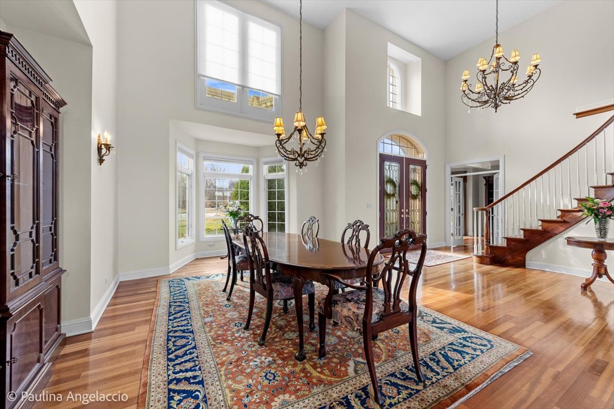 1175 Woodburn Court Inverness, IL 60067 - Photo 7 of 68 a view of a dining room with furniture a chandelier and wooden floor