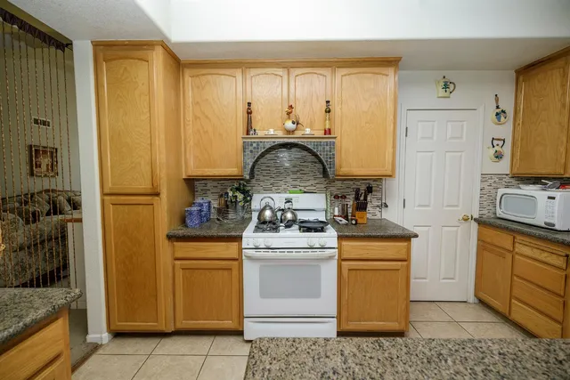 a kitchen with stainless steel appliances granite countertop sink stove and cabinets