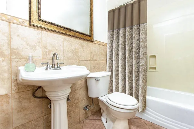 a bedroom with a bed and a ceiling fan