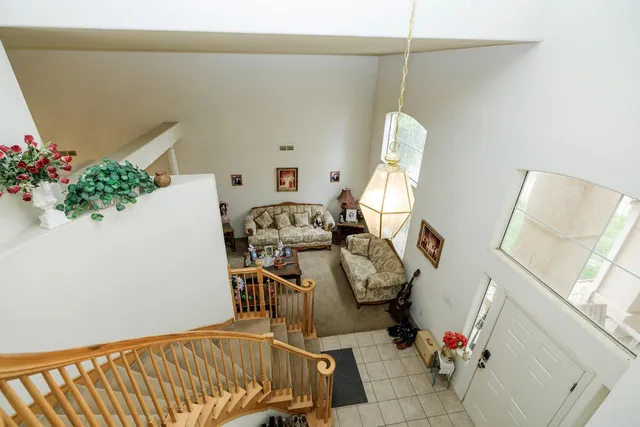 a view of a dining room with furniture and a chandelier