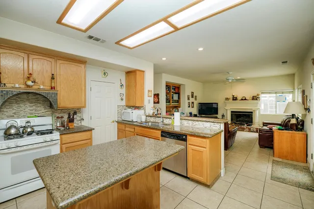 a kitchen with granite countertop a sink and cabinets