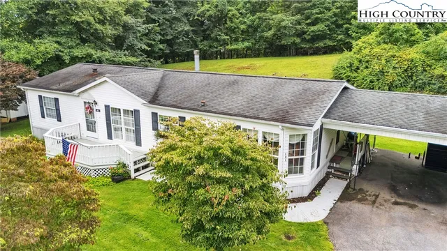 a aerial view of a house with a yard table and chairs