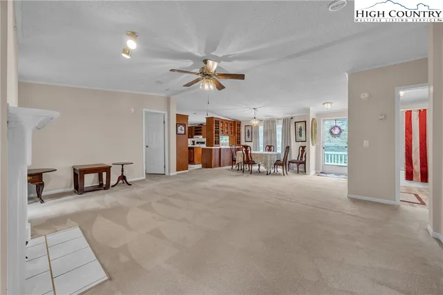 a view of a livingroom with furniture and a ceiling fan